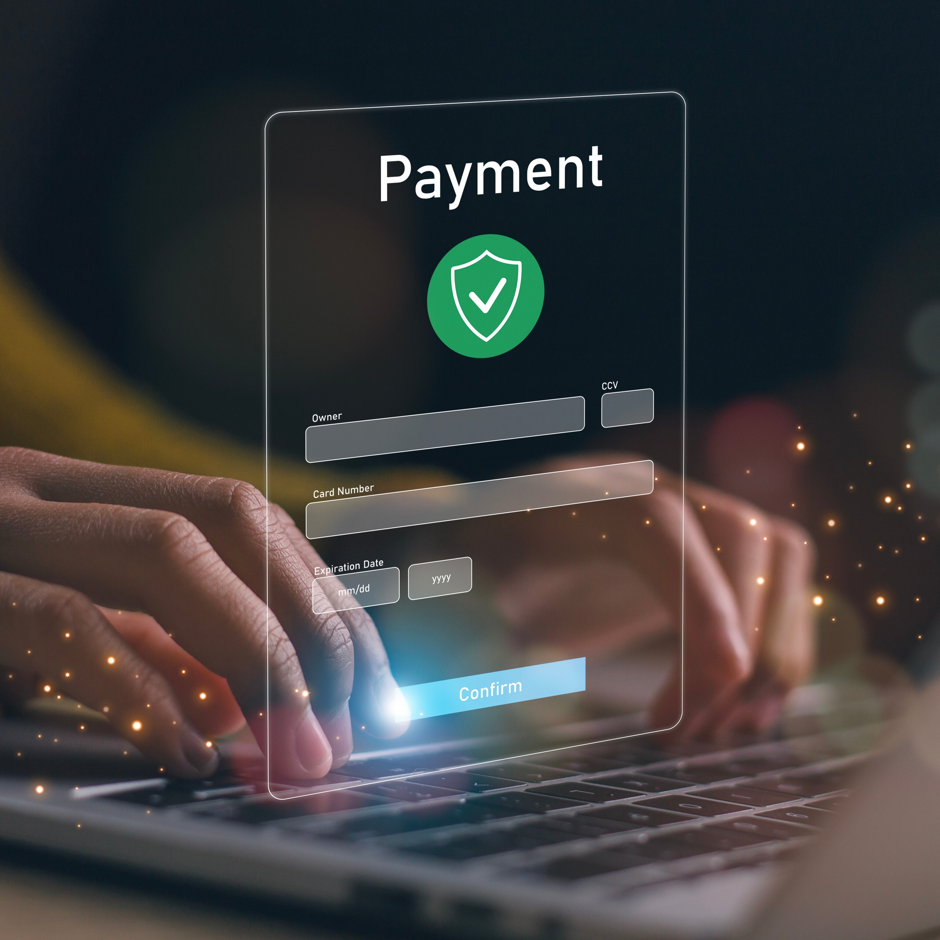 A person typing on a laptop with a digital overlay of a payment form showing card details and a